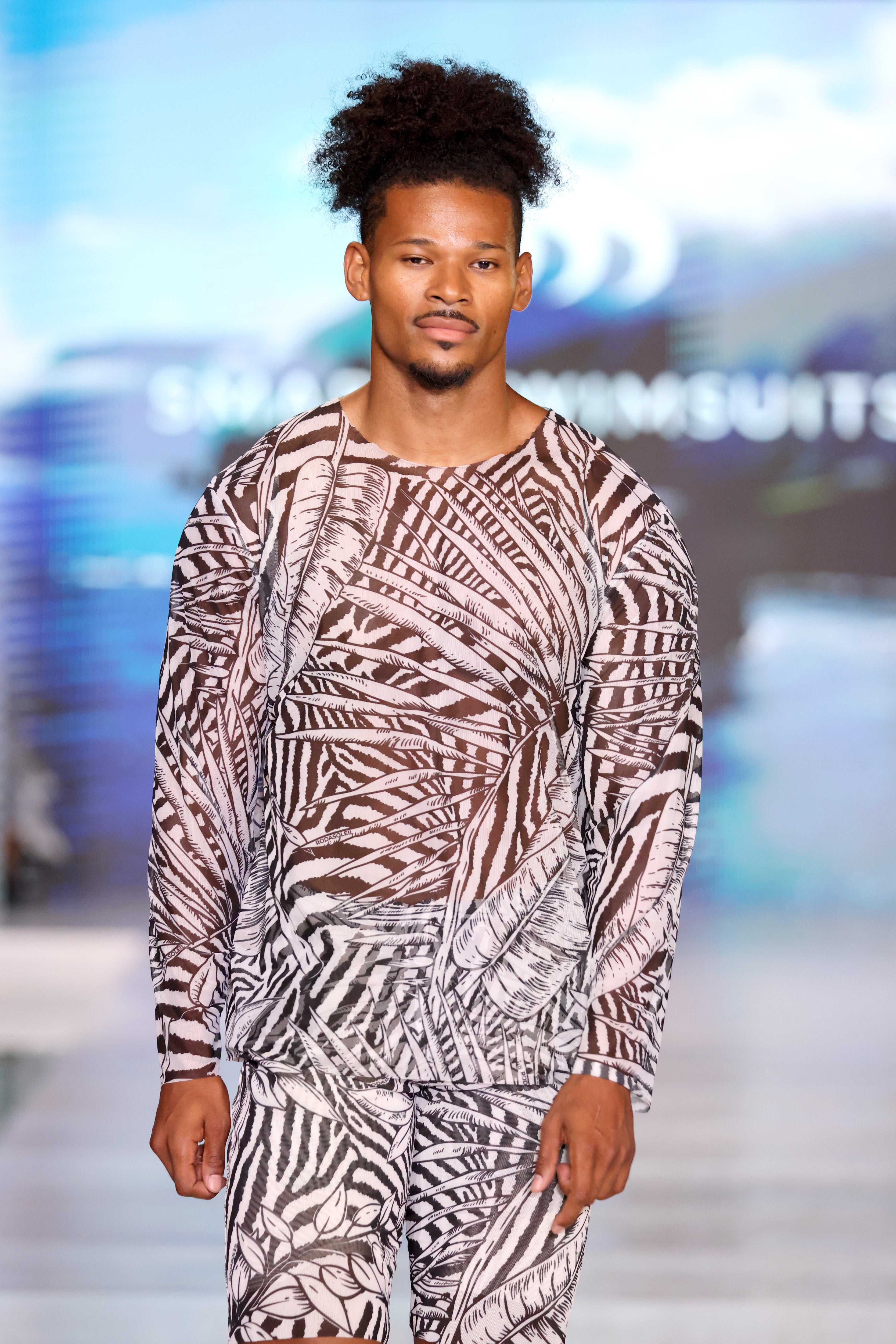 Explore our sustainable men's swimwear collection featuring a Zebra print beach t-shirt with hood and SPF35 protection. Designed for classic luxury and eco-friendly style, perfect for beach outings