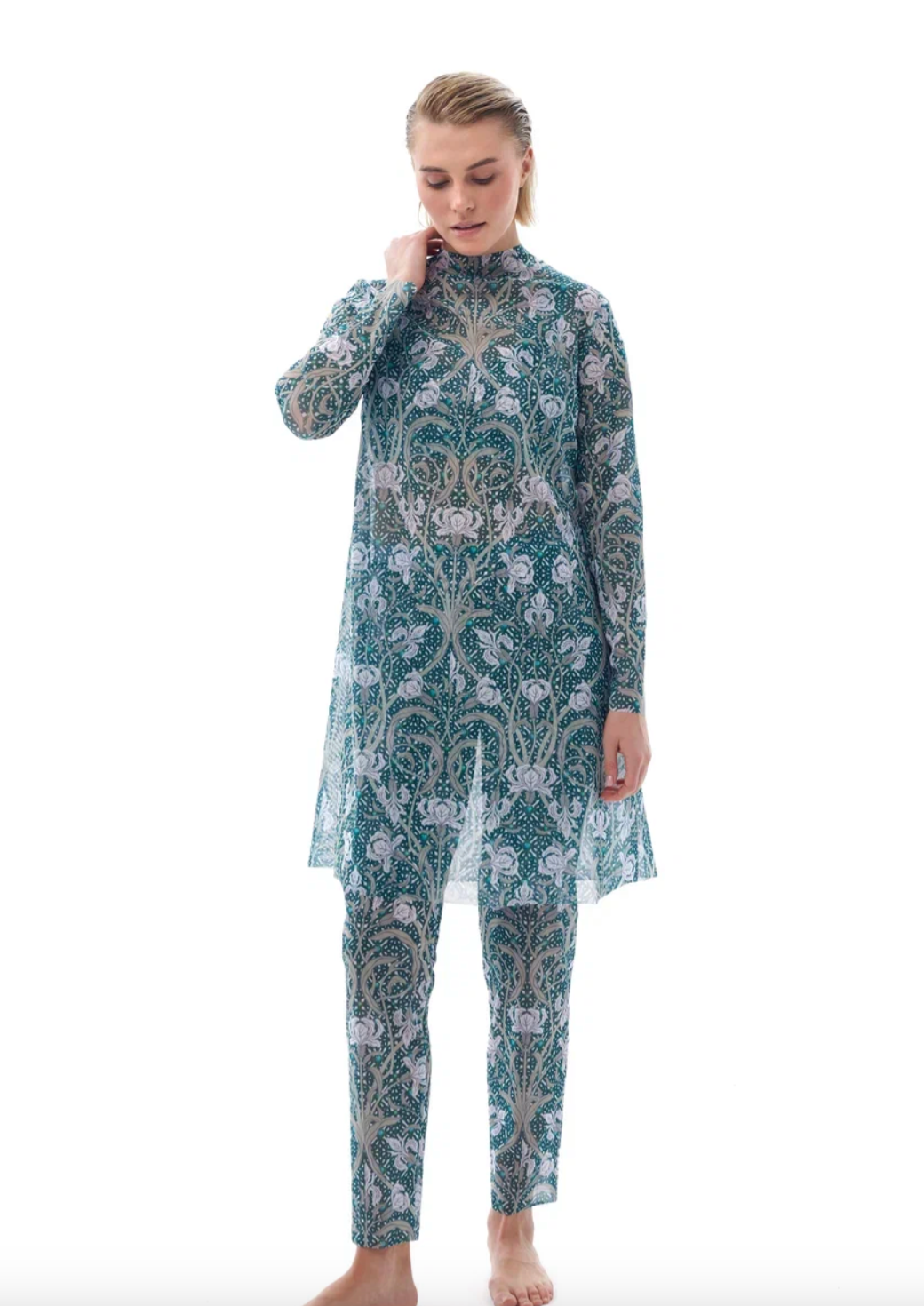 This file describes a tan-through, innovative, sustainable burkini set with an Irises print. The set includes a top, leggings, and a tunic, providing classic luxury for modest fashion. Shop now!