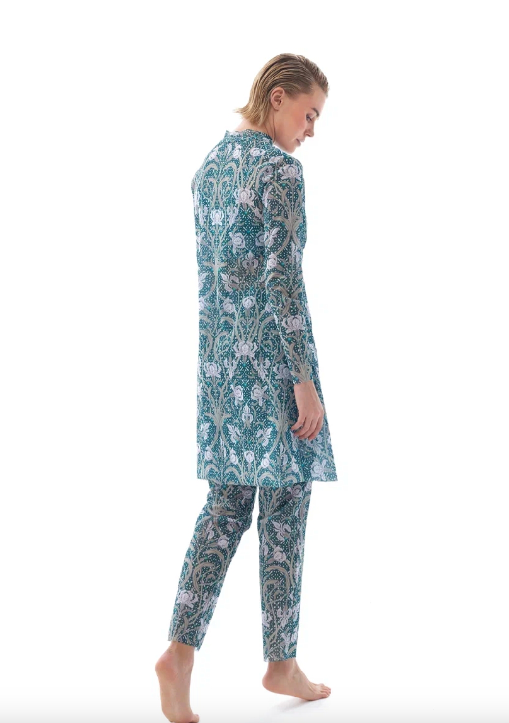 This file contains a description of a tan-through burkini set with an Irises print. It includes a top, leggings, and tunic, offering innovative, sustainable, classic luxury for modest fashion. Shop now!