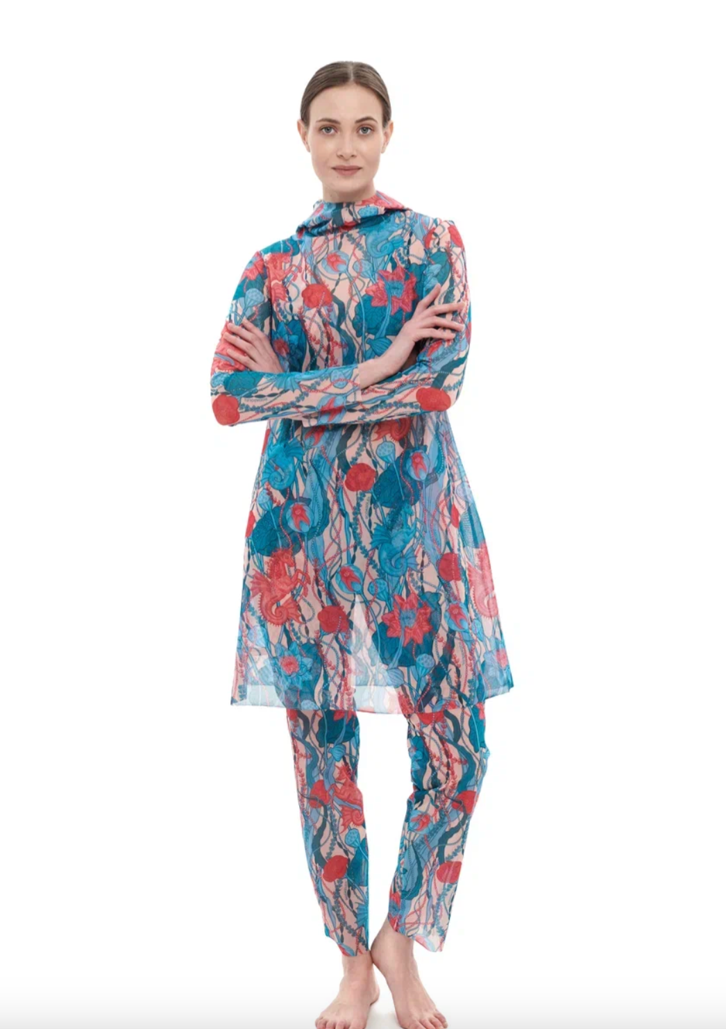 This file describes a tan-through, sustainable burkini set with a Seaunicorns print. It includes a top, leggings, and a tunic, providing innovative, classic luxury for modest fashion. Shop now!