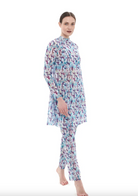 This file describes a sustainable, tan-through burkini set with a Strelitzia print. It includes a top, leggings, and tunic, providing classic luxury for modest fashion. Shop now