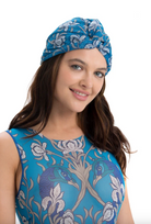 This file describes the SWANS print turban, which is one size fits all. It combines fashion and function, providing classic luxury for modest fashion. Encourages shopping now for stylish, eco-friendly headwear.