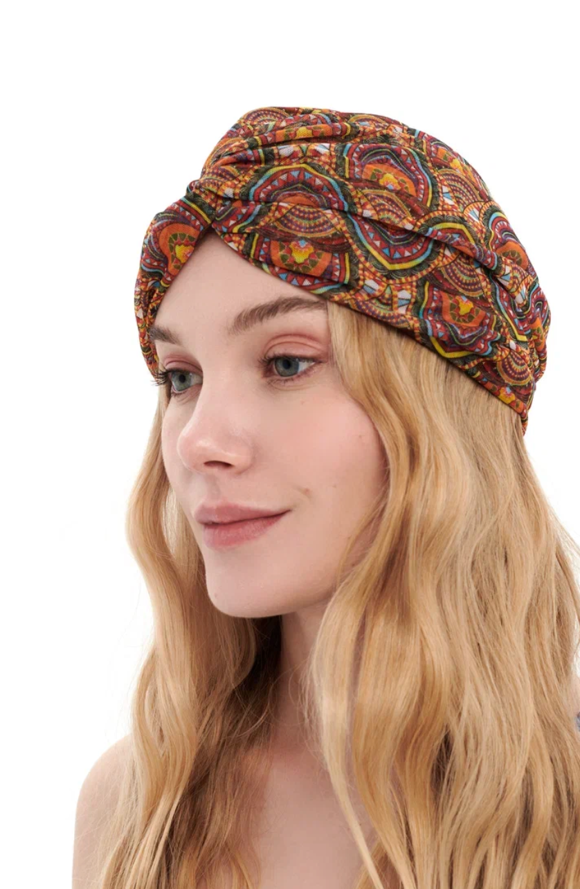 This file contains a description of a one-size-fits-all ETHNIC print turban. It offers classic luxury for modest fashion and includes a call to action to shop now for elegant, eco-friendly headwear.