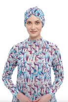 This file contains a description of the STRELITZIA print turban, one size fits all. It offers classic luxury for modest fashion and includes a call to action to shop now for elegant, eco-friendly headwear.