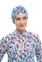 This file describes the STRELITZIA print turban, which is one size fits all. It combines fashion and function, providing classic luxury for modest fashion. Encourages shopping now for stylish, eco-friendly headwear.