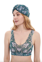 This file describes the IRISES print turban, which is one size fits all. It combines fashion and function, providing classic luxury for modest fashion. Encourages shopping now for stylish, eco-friendly headwear.