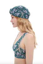 This file contains a description of a one-size-fits-all IRISES print turban. It offers classic luxury for modest fashion and includes a call to action to shop now for elegant, eco-friendly headwear.