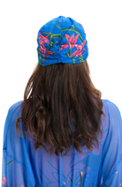 This file contains a description of a one-size-fits-all LILY print turban. It offers classic luxury for modest fashion and includes a call to action to shop now for elegant, eco-friendly headwear.